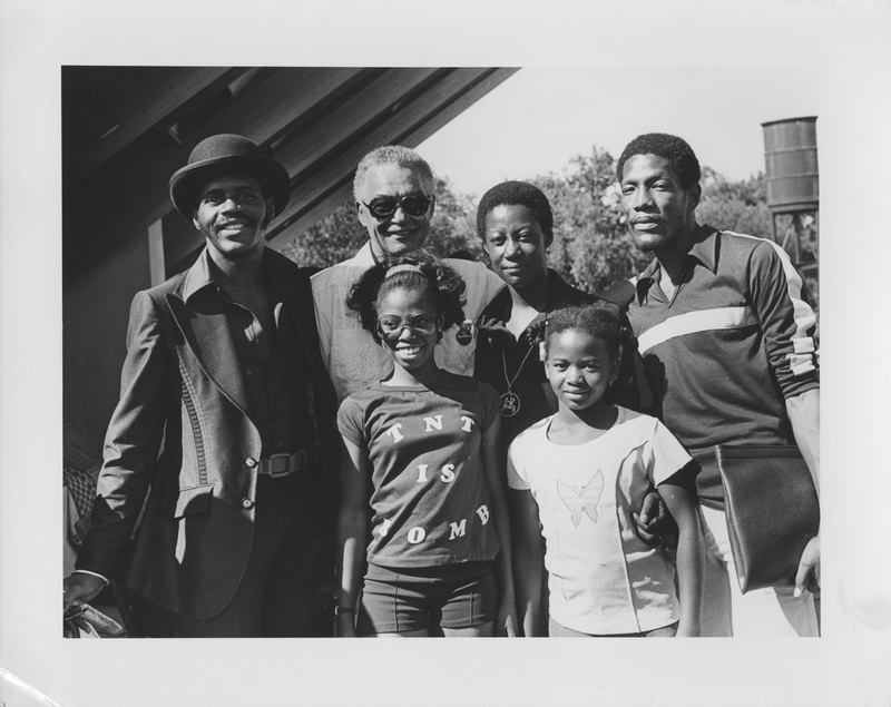 Mayor Young posing with unidentified Detroit residents.